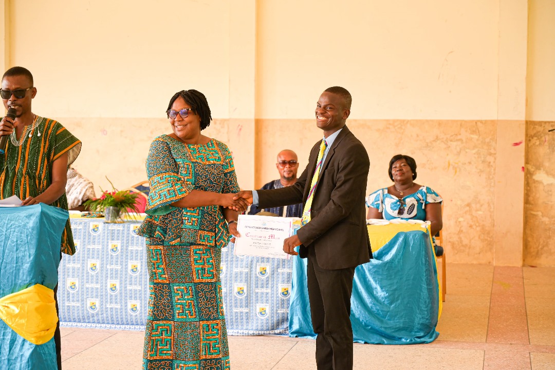 Charles Anaba receiving a certificate of merit at Gomoa Gyaman Senior High School